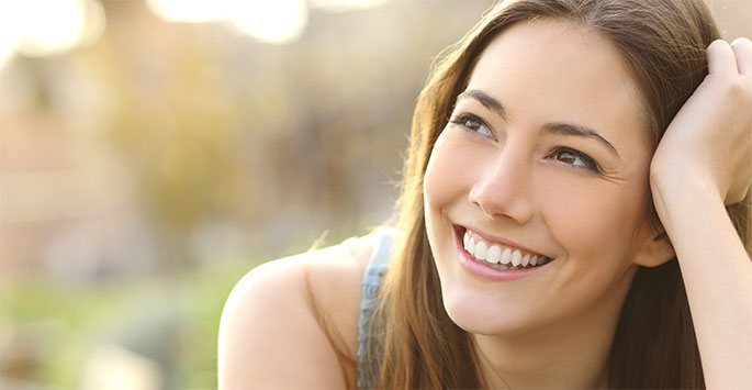 Confident young woman outside smiling