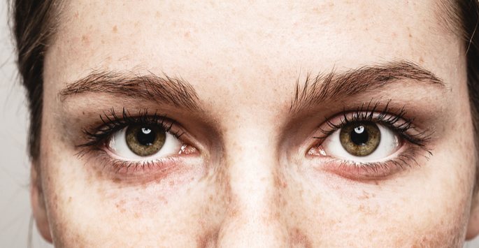 Close-up of a woman's green/brown eyes
