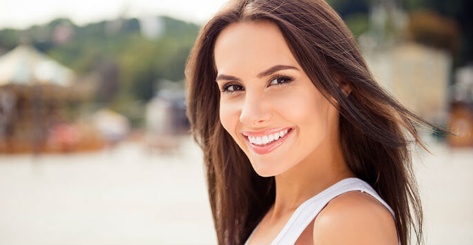 Brunette woman smiling outdoors
