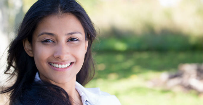 Young woman with long black hair smiling