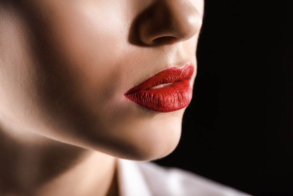 Close-up of a woman's mouth in red lipstick