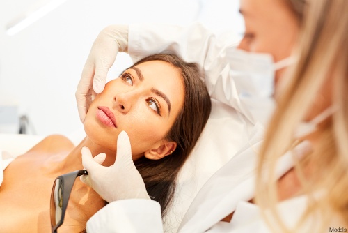 Female physician examining a female patient's face prior to a laser treatment